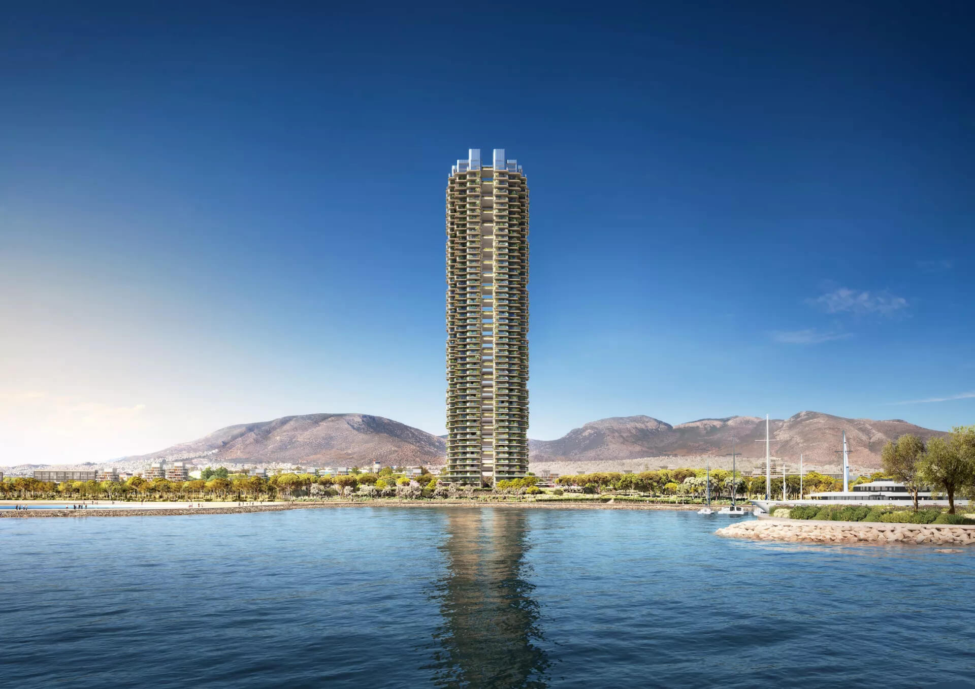 A multi-storey tower in front of the sea. Behind it, trees; to the right, a section of the marina with boats.