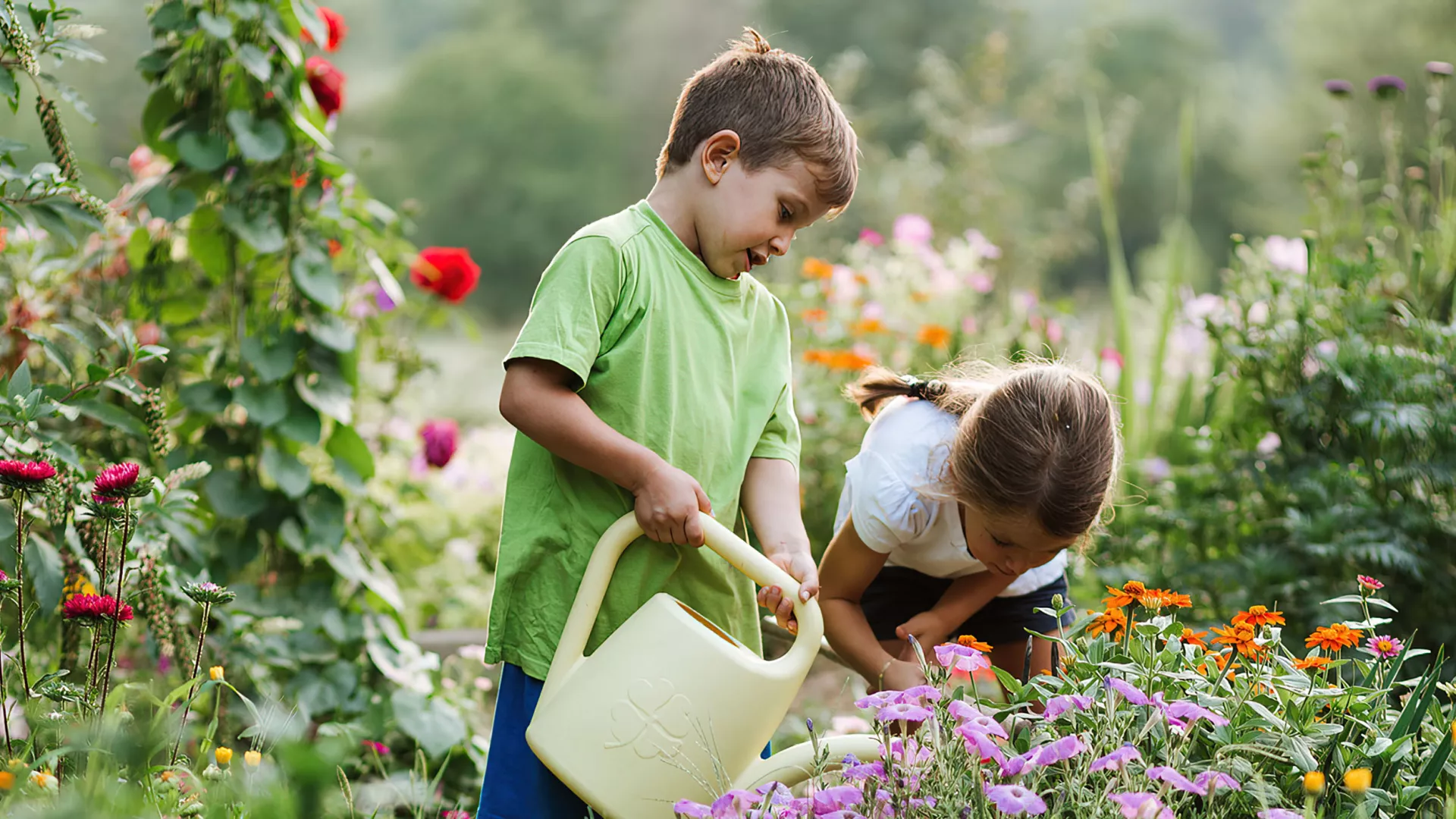 children watering plants at the ellinikon